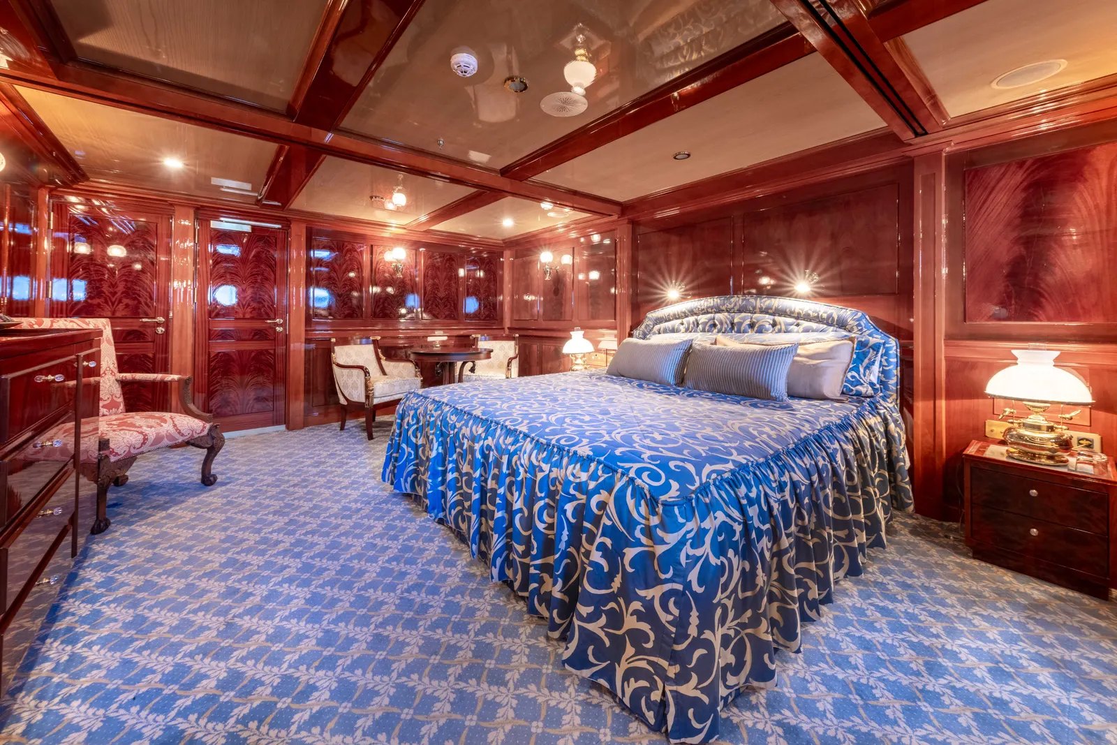 A suite with a timber panelled king bed.