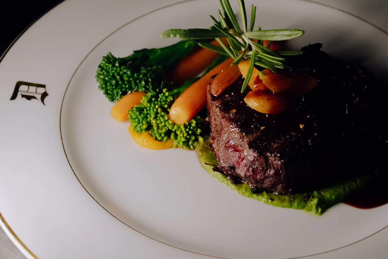 A plated main course of beef and vegetables on the yacht's own china.