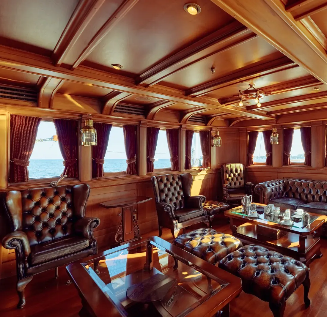 Leather Chesterfield armchairs and sofa in the wood-panelled smoking room aboard SS Delphine today.